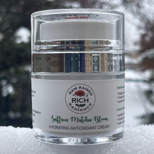 Rich Radiance Saffron Matcha Bloom hydrating antioxidant cream jar resting on snow